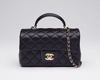 A BLACK LAMBSKIN RECTANGULAR MINI TOP HANDLE FLAP BAG WITH LIGHT GOLD HARDWARE by  CHANEL sold for $7,500