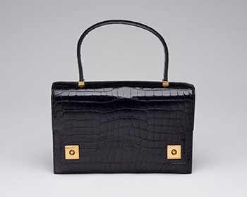 A VINTAGE BLACK POROSUS CROCODILE PIANO BAG WITH GOLD HARDWARE by  HERMÈS sold for $6,250