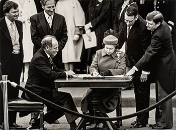 The Queen signs Canada’s constitutional proclamation in Ottawa on April 17, 1982 as Prime Minister Pierre Trudeau looks on by Ron Poling sold for $1,375