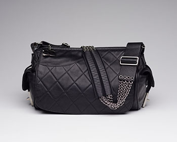 A VINTAGE BLACK QUILTED LEATHER BARREL BAG by  CHANEL