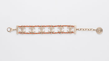 A WOVEN BROWN LEATHER AND METAL CHAIN BRACELET by  CHANEL