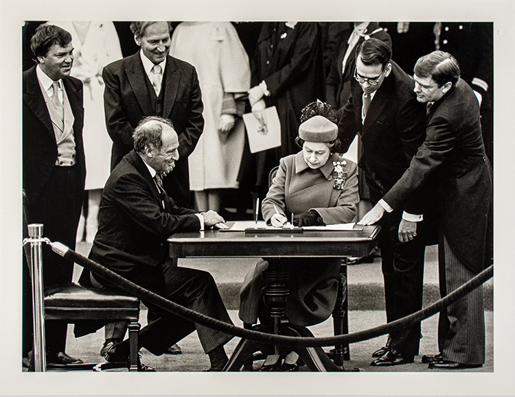 The Queen signs Canada’s constitutional proclamation in Ottawa on April 17, 1982 as Prime Minister Pierre Trudeau looks on by Ron Poling